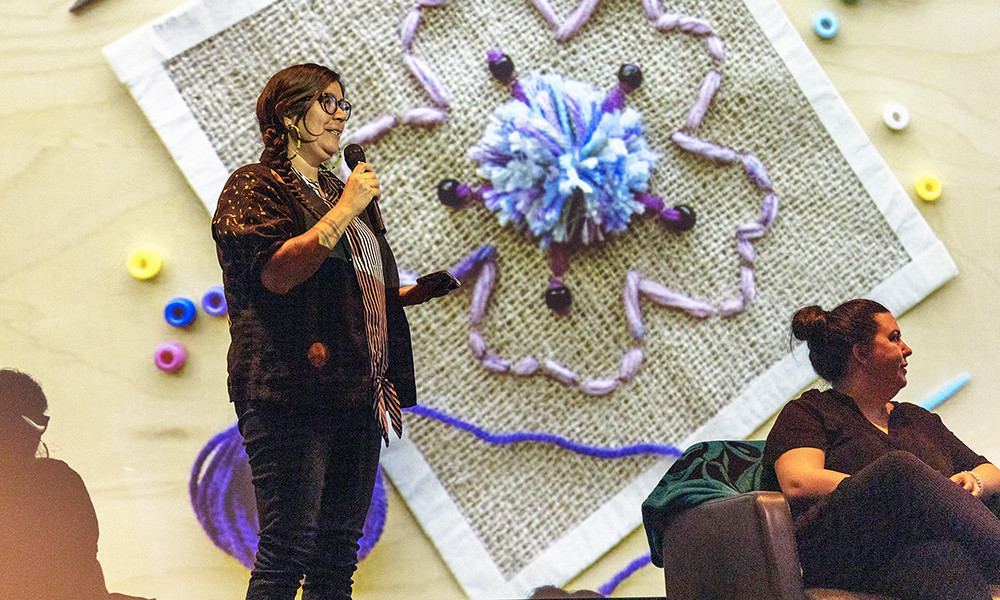 two women discuss art during a panel event 