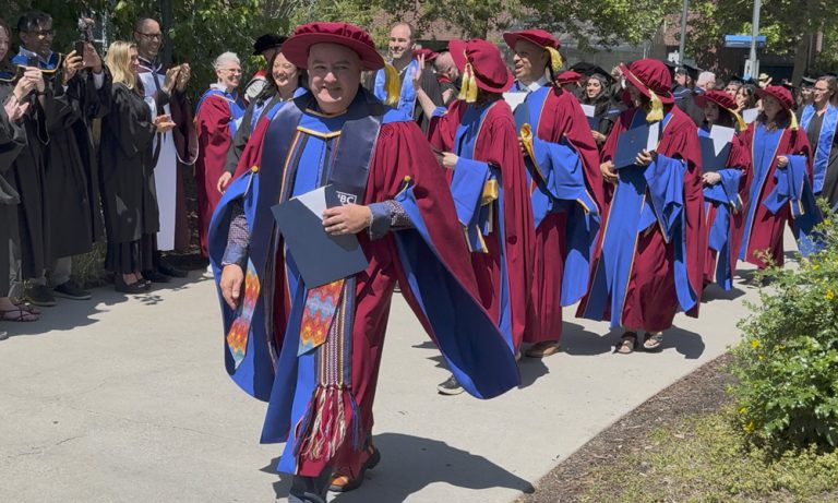 Doctoral student Jon Corbett in the procession